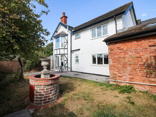A house with a well and seating area at The Annex at The Lodge Shawbury