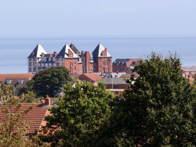 A view of buildings and trees with the sea in the background at 26 Metropole Towers Whitby