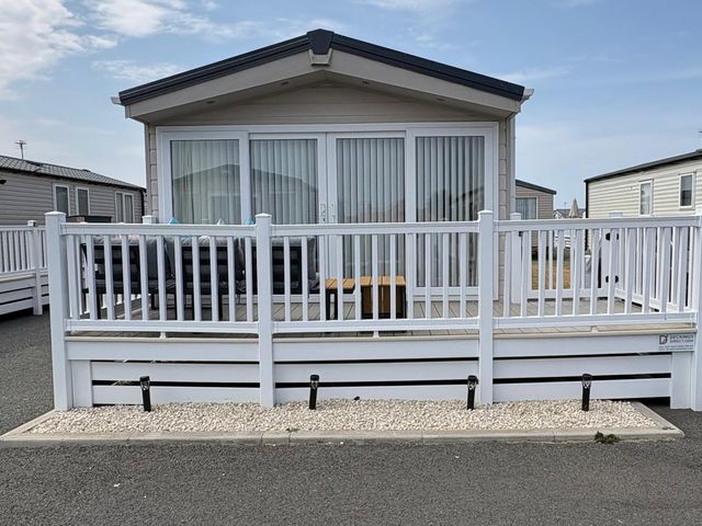 An outdoor patio area with furniture at Lyons Robin Hood in Rhyl
