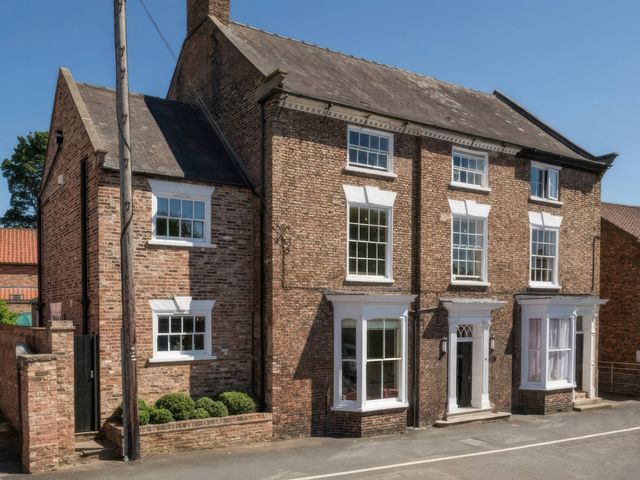 A house with multiple windows and a door at Cadogan House Easingwold