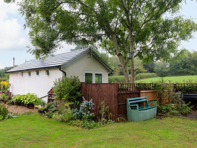 An outdoor view of a garden area with a building and trees at Lodgeview in Nottingham