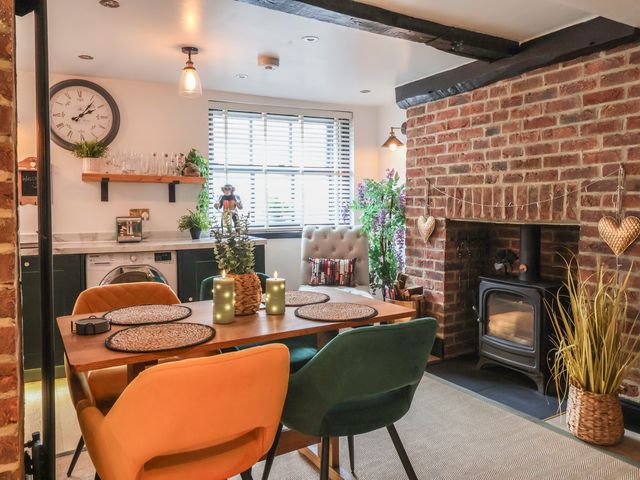 A dining room with a table and chairs at Cathedral Mews in Ripon