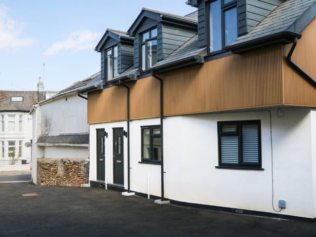 A house with multiple windows and doors at Greenswood Mews in Brixham