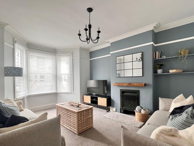 A living room with a coffee table and a television at 4 Bed House Sleeps 8 Garden Pets Near Beach Llandudno