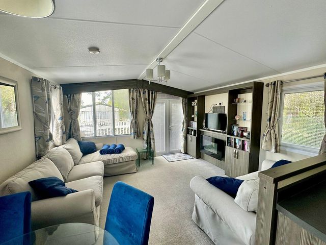 A living room with a sofa and television at 2Bed Ringwood Cabin incl Park Pass SelfCheckin Saint Leonards near Ferndown