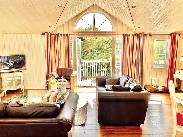 A living room with a television and sofas at Stunning Sleeps 6 Luxury Lodge Pets Mercia Marina near Willington, Derbyshire