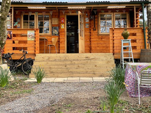 A wooden cabin with stairs and outdoor seating at The Cabin Retreat in Sidmouth