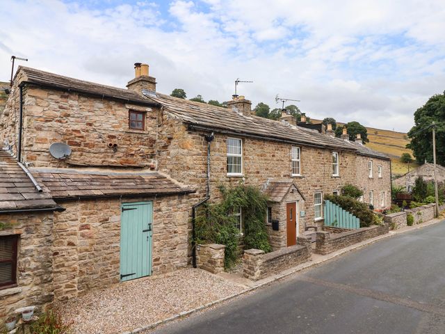 A stone house with a garden and pathway at South View in Richmond