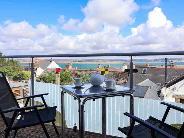 A balcony with a table set for tea at 1 Tideways in Bideford