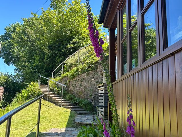 An outdoor area with stairs leading to a pathway at The Old Forge in Hallsands