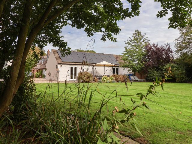 A house with a garden and patio at Millstone Cottage Leven Near Beverley