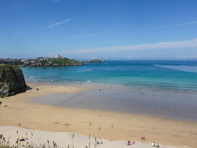 A beach with sand and people at Seaside Retreat in Newquay