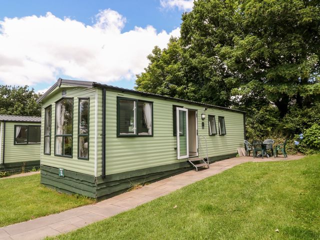A holiday home with a patio and chairs at Great Mis Tour in Tavistock
