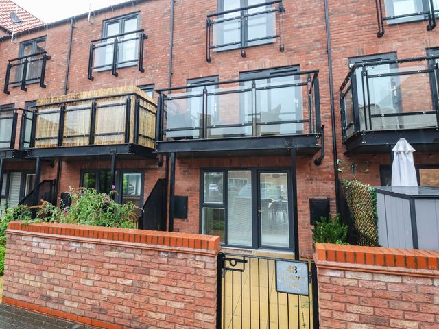 An apartment building with balconies and a gate at Blanket Row in Hull