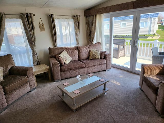 A living room with a sofa, armchairs, and a coffee table at the property in unspecified location