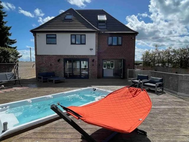 An outdoor area with a hot tub and seating at Hot tub  BBQ  Garden Parking  Sleeps 8 in Worcester