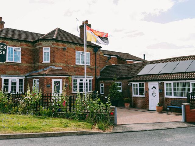 A building with a flag and garden at 1 Bed Sleeps 3 Free Parking Pets Allowed in Dereham