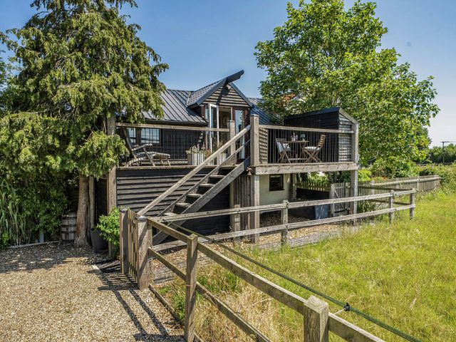 A house with a deck and stairs at Hayloft Sleeps 3 with Enclosed terrace Dereham