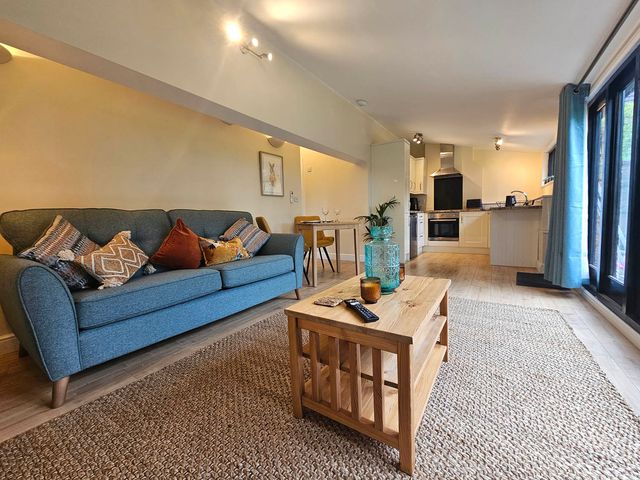 A living room with a sofa and dining area at Lily's Cottage Suffolk Sleeps 2 with Pets in Mendlesham Green near Stowmarket