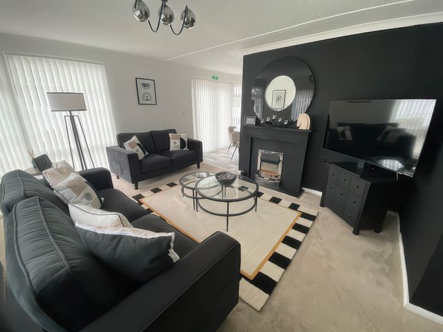 A living room with sofas and a television at Paddock View Snetterton Norfolk near East Harling