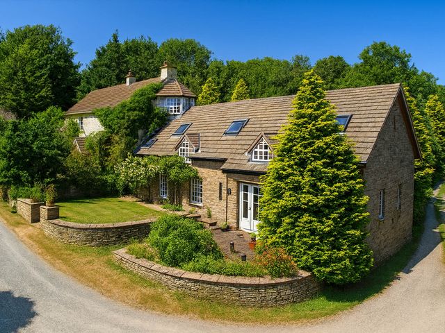 A house with trees and a garden at The Hills Farmhouse 6 Bed Sleeps 11 Pets Llanfilo near Talgarth