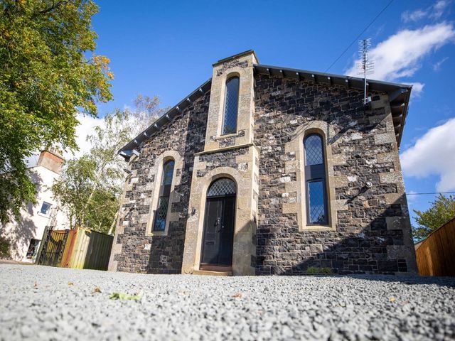 A stone building with windows and a front door at Stunning 3 Bed Converted Village Hall Near Kelso Nenthorn near Kelso