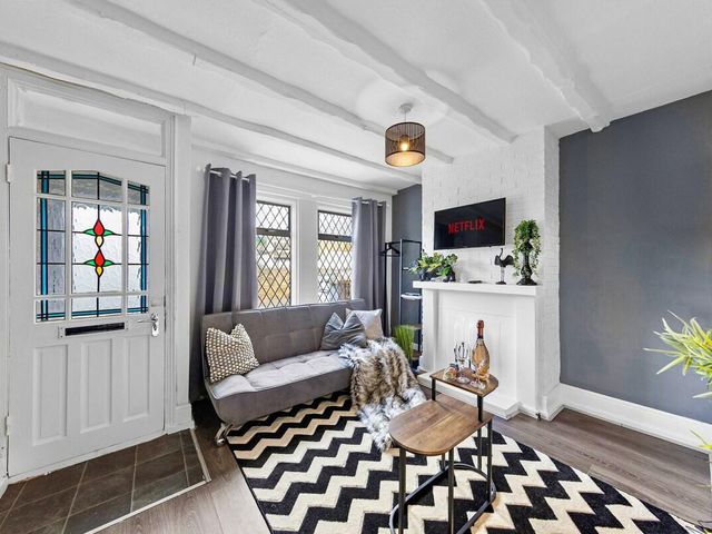 A living room with a grey sofa and a television at Apartment Sleeps 7 with Free Parking in Chatham
