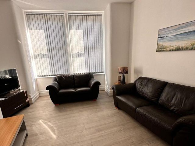 A living room with a television and sofa at Near Beach Parking WiFi Sleeps 2 in Lytham St Annes