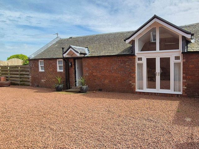 An outdoor area of a brick building with plants and a door at Sleeps6 3Bed Ayrshire Coast Near Beach, Prestwick