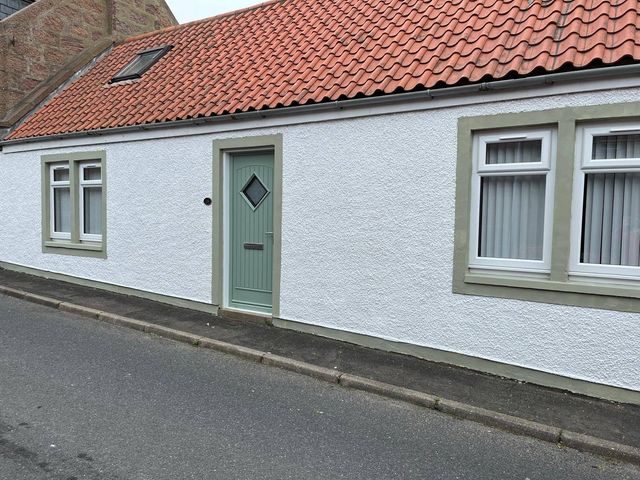 A house facade with a green door and windows at Costal Cottage Boddam Sleeps6 Pet Friendly Boddam
