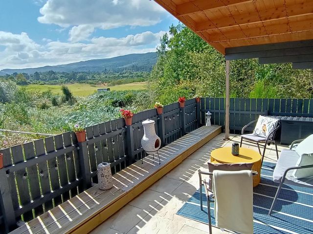 An outdoor seating area with a view at Fairvine Cabin Fort Augustus Mtn View Pet Friendly in Fort Augustus