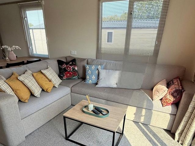 A living room with a sofa and table at 3Bed Sleeps 6 Parking Balcony Flamingo Land Resort near Kirkby Misperton