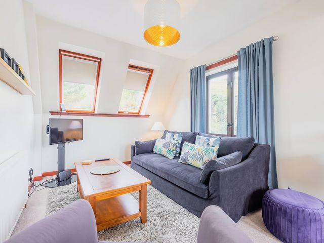 A living room with a sofa and coffee table at the property in Lairg