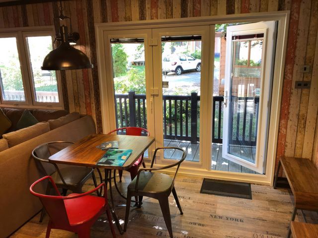 A dining area with a table and chairs at Sandy Balls Holiday Park Pet Friendly Lodge Godshill, Hampshire