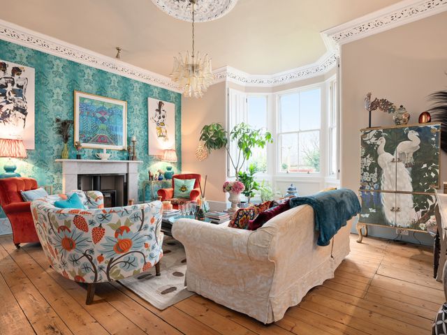 A living room with sofas and artwork at The Old Barn in Manchester