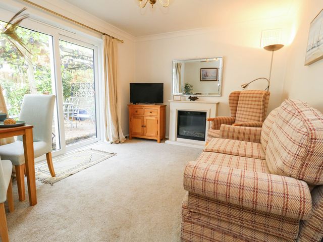A living room with a sofa and television at Sunnydale near Corfe Mullen