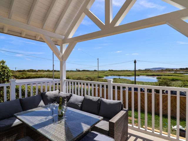An outdoor seating area with a table and couch at 30 Southdown Avenue Weymouth