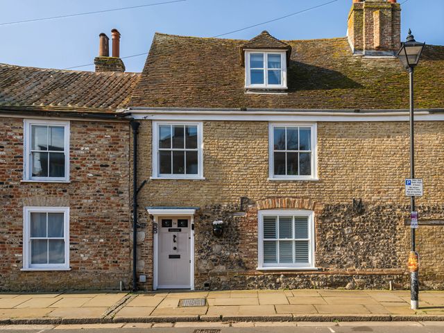 An exterior view of a house with brick and stone facade at CobNut Cottage in Sandwich