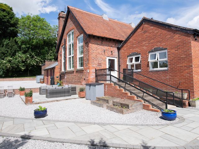 A building with steps and seating area in an outdoor area at The Old School House 