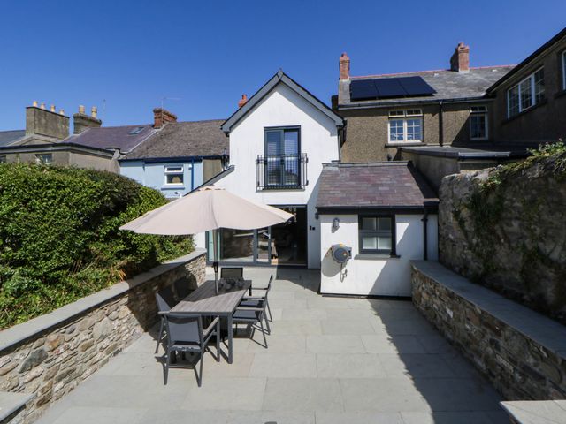 An outdoor patio with table and chairs at Rheidiol in St Davids
