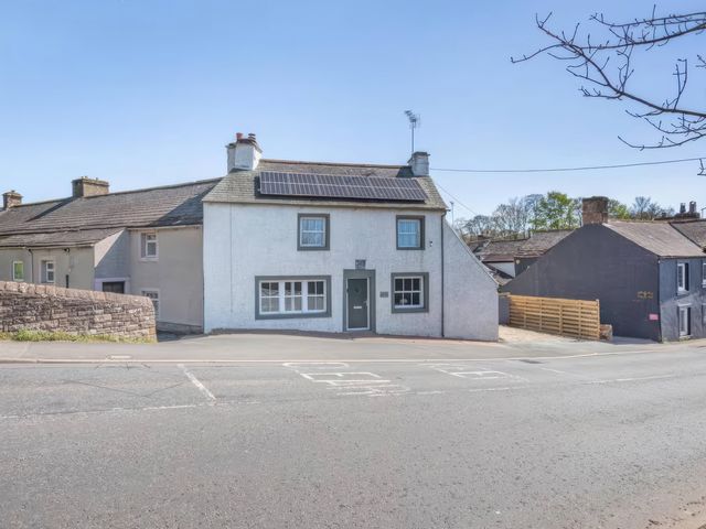 A house featuring solar panels and windows at The Quirky Cottage near Eamont Bridge