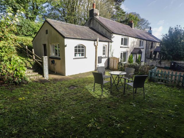 A garden with a table and chairs at Ty'r Wennol in Fishguard