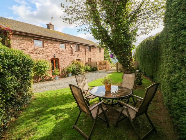 A garden area with a table and chairs at Greig House Cottage Abergavenny