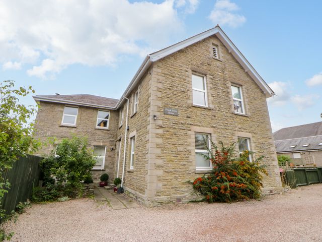 A stone house with windows and a garden at Flat 5 Hereford