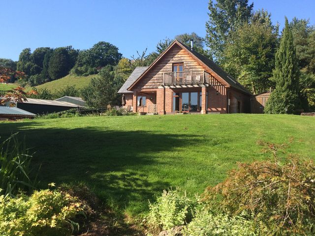 A house with a balcony and garden at Chestnut Lodge in Worcester