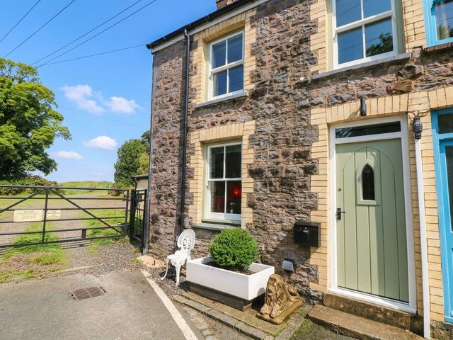 A house entrance with a stone wall and garden features at 11 Church Street Narberth