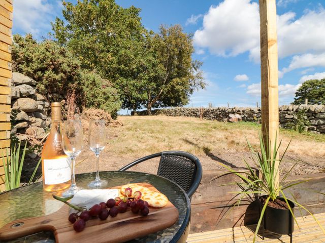 An outdoor area with wine glasses and a bottle at Windy Ridge Lodge in Egton