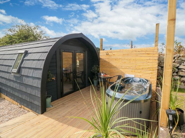 An outdoor area with a hot tub and seating at Windy Ridge Lodge in Egton