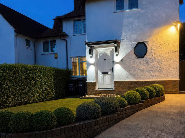 A house exterior with a front door and landscaped garden at 35 Vivian Gardens in Watford