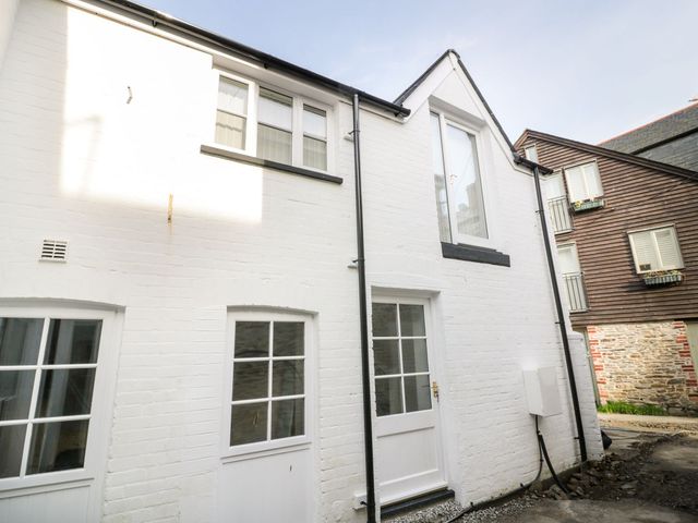 An exterior view of a white building with windows and doors at Fishermans Loft in Mevagissey